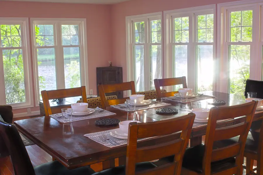 Sunroom dining area with a water view at Casa Blue Heron