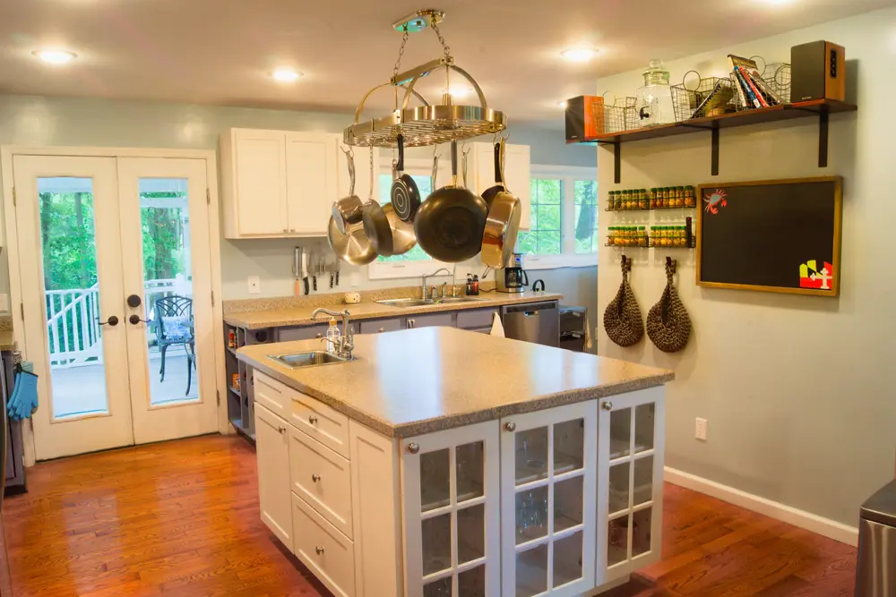 The kitchen at Casa Blue Heron, with hanging pots, a spice rack, and a chalkboard menu board