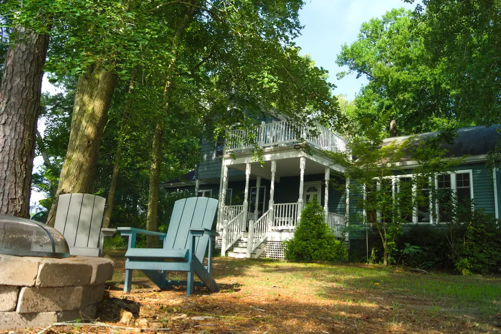 Casa Blue Heron's porch and firepit seating, tucked among the trees